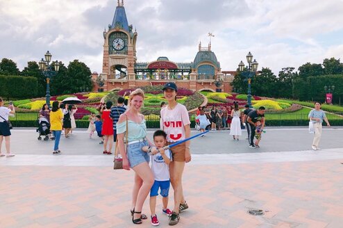 Two women and a child posing outside.