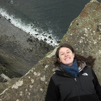 A student laying by a cliff